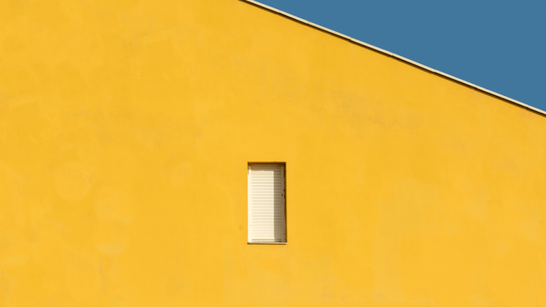 yellow and blue lines with a white door in the yellow wall