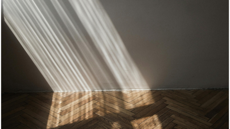 light rays shining into a room onto wall and floor